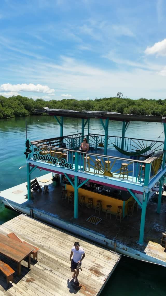 Guests on the decks and dock at the flagship Floating Bar on a sunny day