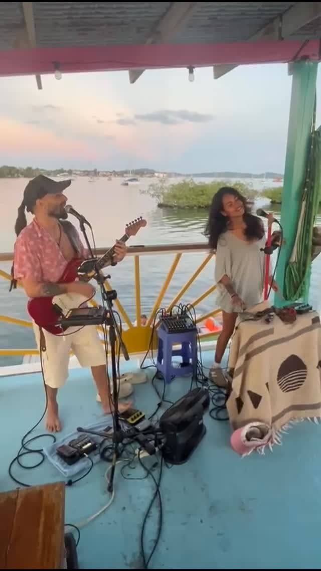 Live duo performing on deck at sunset — guitar and vocals for Live Music Mondays
